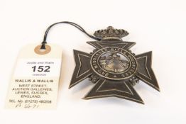 A Victorian officer's helmet plate of the 24th Middlesex Rifle Volunteers, blackened with polished