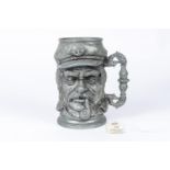 A heavy Third Reich pewter beer stein, cast with grotesque face and engraved "U107 Erinnerung A.D.