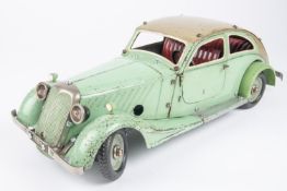 A Marklin clockwork Constructor Car. Bolt together panels in mint green with beige roof and red