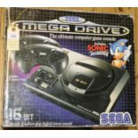 A Sega Mega Drive games console. 16-bit console with 2x controllers. Boxed with inner packing