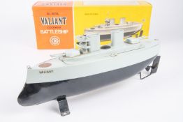 A Sutcliffe Model Valiant clockwork tinplate Battleship. In black and blue-grey. Complete with mast,