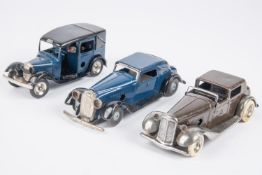 3 Tri-ang Minic clockwork cars. A pre-war Town Coupe (7M). An example in dark brown with a