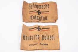2 Imperial German armbands both printed on brown linen; Deutsche Polizei Tsingtau Bahnhof, and
