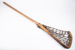 A Victorian wooden lacrosse stick, with leather strapping. GC £40-50