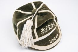 A Rugby football prize cap, green velvet with white piping, embroidered "B.S.R.F.C 1063-64". VGC £