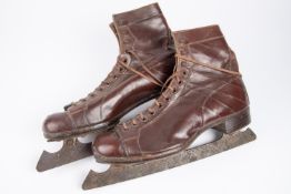 A pair of Embekay vintage ice skating brown leather boots, steel blades marked "51" and "John Wilson