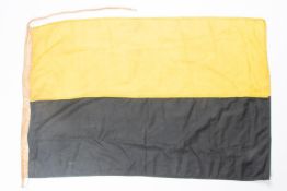 A WWI Austrian flag 38" x 24", black and yellow with label marked K.U.K. KriegsMinisterium