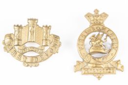 A brass glengarry badge of the First or East Devon Militia, c 1890; and another, of the First