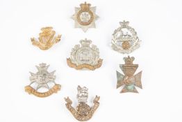 7 Victorian Infantry cap badges: Devonshire, Suffolk, East Lancs, Derbyshire, Loyal North Lancs (one