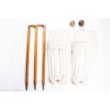 A set of vintage cricket stumps with bails, oak with brass top mounts; together with 2 leather