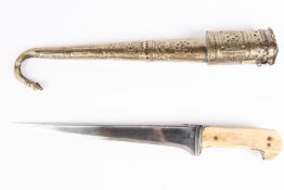 An Afghan pesh kabz, blade 11", walrus ivory grips, in its hammererd brass sheath with inset red