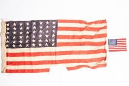 A small WWII US flag, 48 stars, 34" x 18" (badly worn); also a US Army arm flag. GC £80-100