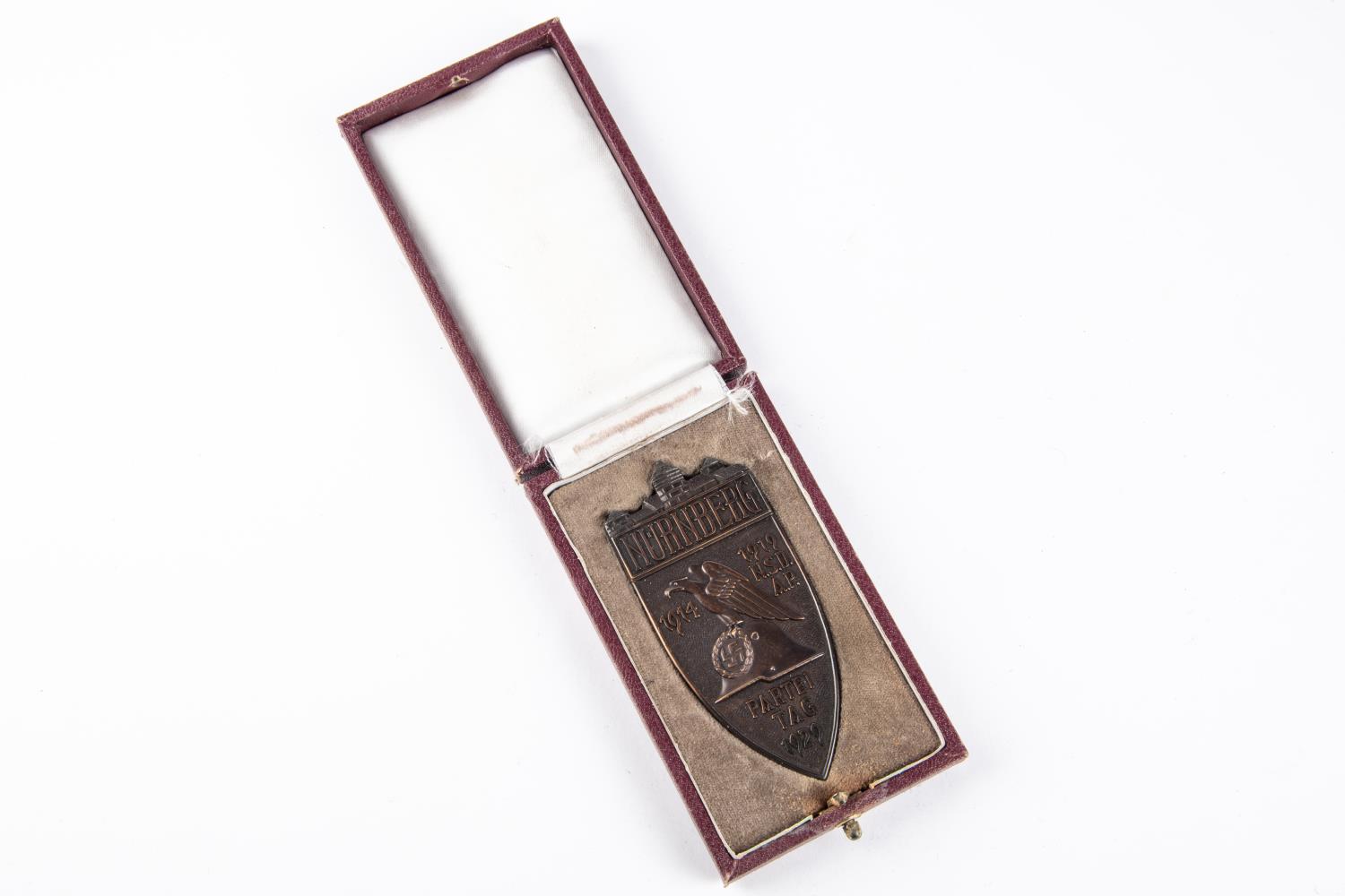 A Third Reich Nuremburg badge of Honour 1929, non portable award, original case and in bronze with