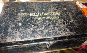 A black metal uniform trunk, the lid bearing the name "Condr. N.C.H. Bristow. No 7663363",