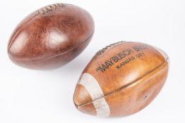 A brown leather vintage rugby ball; also an American Football marked "Maybusch Bros. Kansas City".