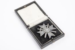 A Third Reich War Service Cross, 1st class with swords, silvered finish, in its case of issue. GC £