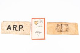 A white armband stamped "ARP", another similar stamped "Shelter Marshal Hammersmith"; also a booklet