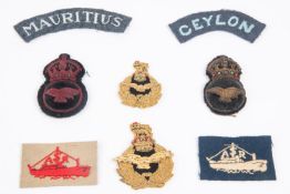 A selection of good quality post WWII made RAF Nationality titles (18), good RNAS NCO's cap badge,