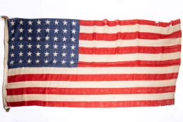 An original WWII 48 star US flag, 68" x 34", printed construction. GC (some holes and wear) £200-250