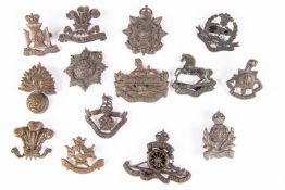 Nine officers' bronze cap badges with prongs: post 1926 King's, Gloucestershire, Border, Hampshire