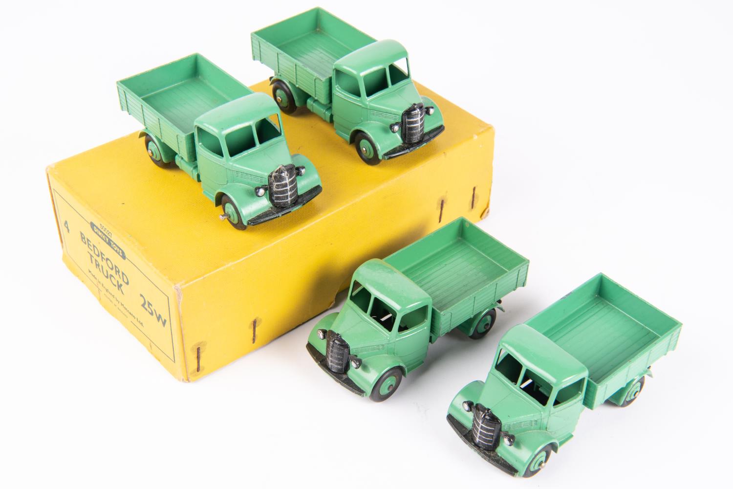 A Dinky Toys Trade Pack of 4 Bedford Trucks (25w). Vehicles with green chassis cab, body and wheels.