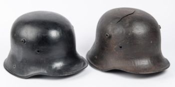 2 WWII German steel helmets, lining missing, black painted (1 with crack). GC £40-50