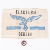 A Third Reich arm band, printed "Flakturm Berlin"; also an NSDAP party badge "Land Off Hitler