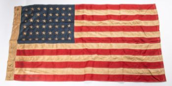A WWII US flag, 60" x 35", all stitched construction with embroidered stars, edge marked "US