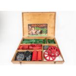 A Meccano branded wooden boxed set, major parts from Outfit No.6. Red and green components including