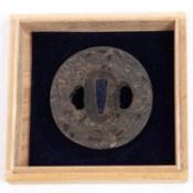 A Japanese bronze tsuba, embossed on one side with leaves, flowers and dragon, and with spurious