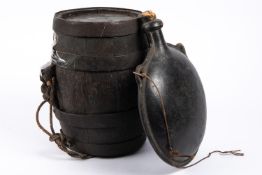 A 19th century discus shaped leather water bottle, with two integral loops for suspension and