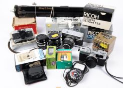 A box of cameras and accessories. Including; an Olympus Trip 35 camera with instructions. A Rollei