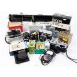 A box of cameras and accessories. Including; an Olympus Trip 35 camera with instructions. A Rollei