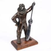 A desk cigarette lighter, in the form of a bronzed figure of an airman in flying suit standing