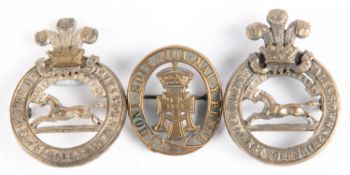 A brass pugaree badge of the Green Howards (The Yorkshire Regt), with stout pin fitting; and two