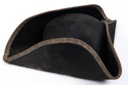 A 19th century tricorn hat, with bullion lace edging to the brim (dull), leather sweat band, and