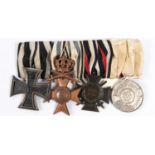 A group of four WWI German medals: 1914 Iron Cross 2nd class, Bavarian Military Merit Order with