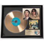 A framed 'gold disc' of the band Oasis' album 'Definitely Maybe'. Framing includes; Gold vinyl LP,