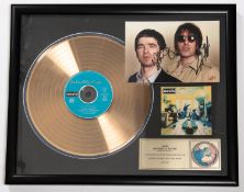 A framed 'gold disc' of the band Oasis' album 'Definitely Maybe'. Framing includes; Gold vinyl LP,