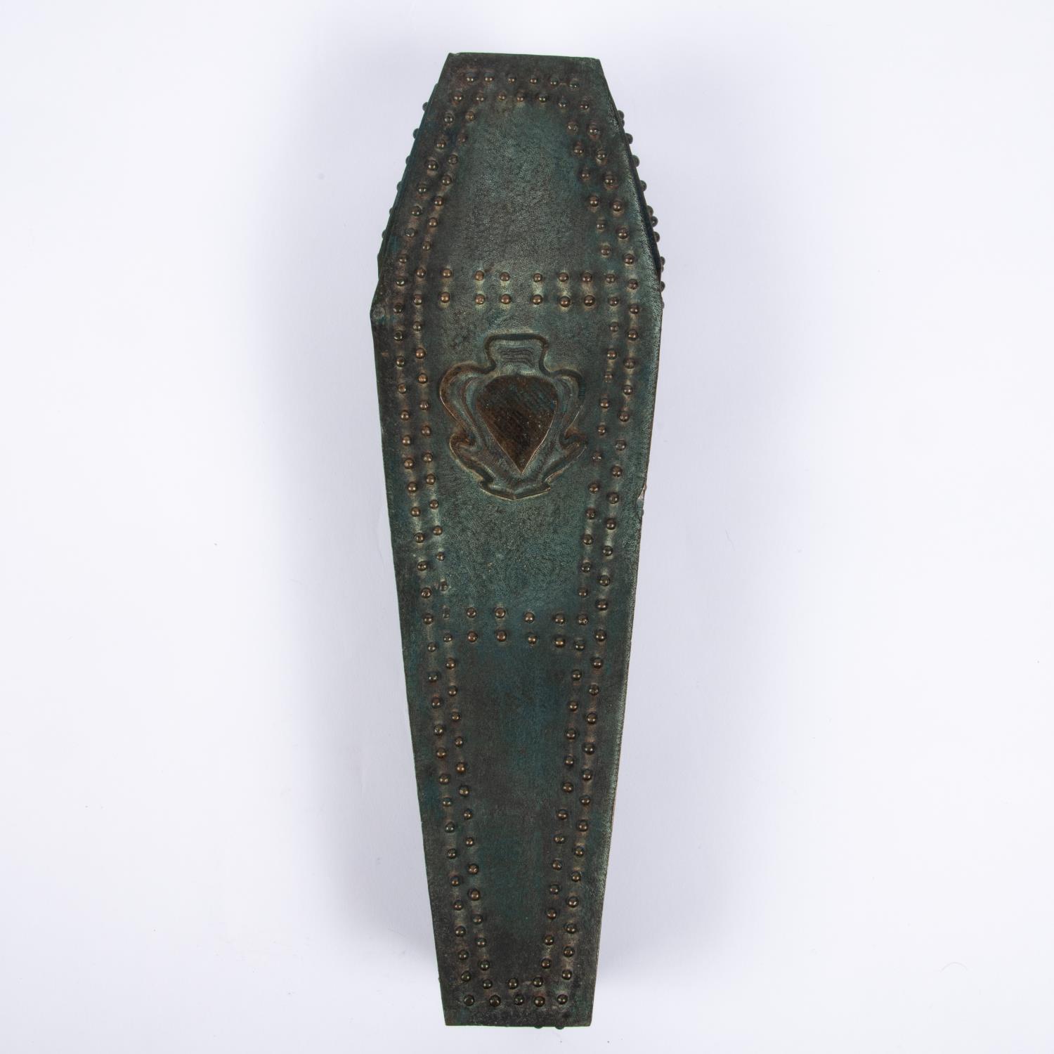 A cast bronze model of a heavily studded coffin with hinged studded lid containing the body of