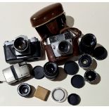 A box of vintage cameras inc. Yashica, and various lenses inc. Carl Zeiss Jena & Flaktogon, etc.