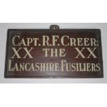 A door plaque "CAPT. R.F. CREER XX THE XX LANCASHIRE FUSILIERS", 32cm x 16.5cm.