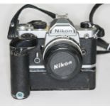 A Nikon FM SLR camera serial no. 2605179 with NIkkor50mm 1"1.8 lens serial no. 2071425 and Nikon