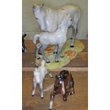 Beswick horses; a grey mare and foal on base, a grey foal and one other.