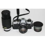 An Olympus OM10 camera with three lenses comprising an Olympus 1:1.8 f=50mm, a Hoya HMC Zoom 70-