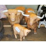 Three Beswick highland cattle; a highland bull, a highland cow and a highland calf.