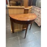 A mahogany demi-lune fold top tea table.