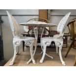 A cast metal garden table and two chairs.