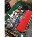 A box of plated ware including boxed napkin rings, bone handled carving set, various cutlery