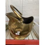 A large brass coal bucket.
